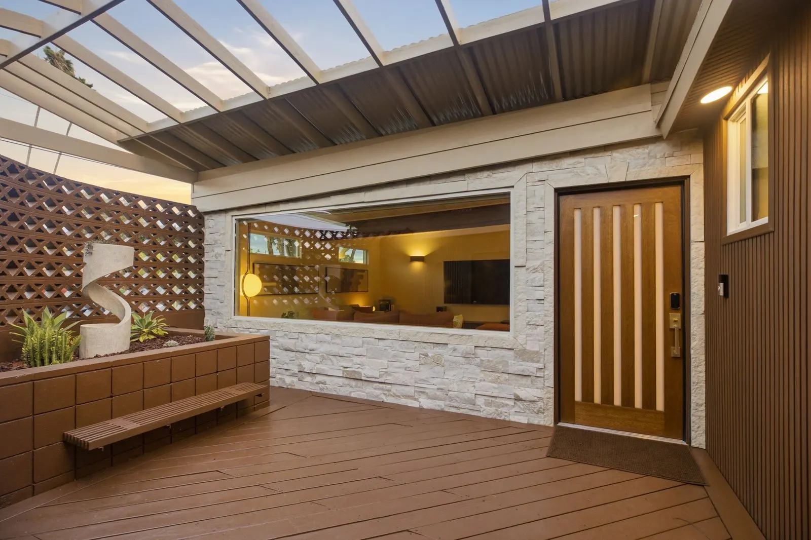 Open-air breeze-block entry atrium and the wood front door