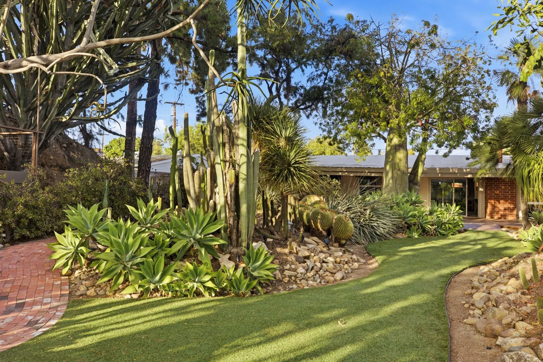 Lawn and garden beds behind the midcentury house