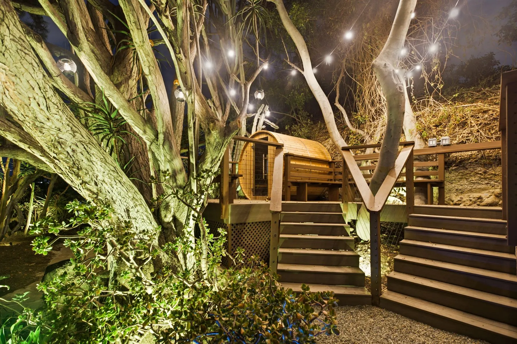 Lit stairs up to the raised sauna and hot tub deck