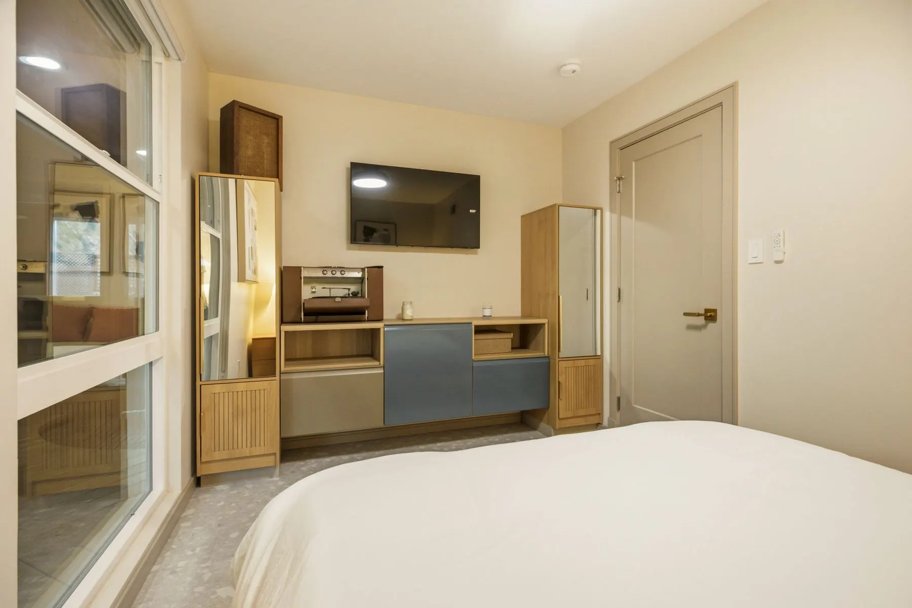 Two mirrored wardrobes, wall-mounted storage and a 42" smart TV
