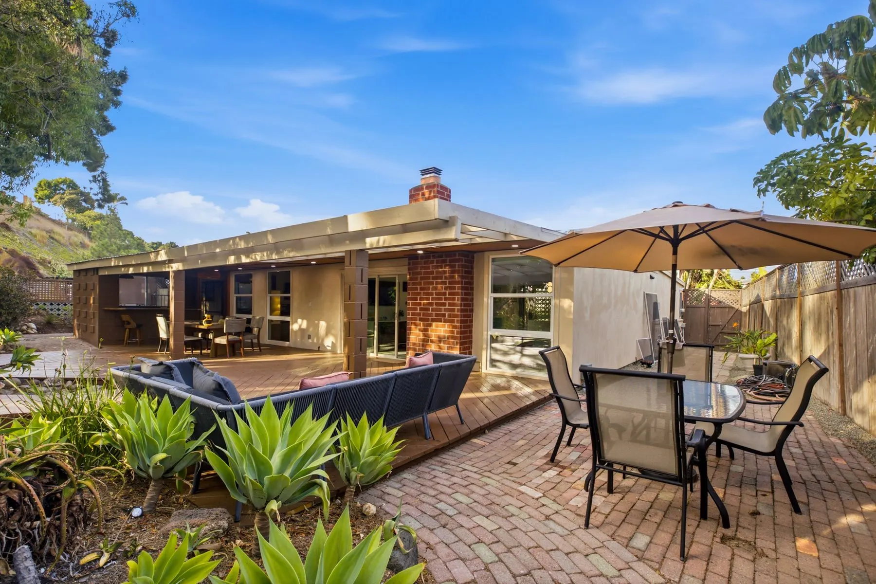 Back patio: lounge seating and umbrella dining